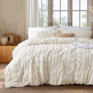 Boho tufted neutral duvet cover styled in cozy minimalist bedroom with warm earth tones