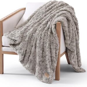 Neutral lightweight throw blanket styled on cozy couch