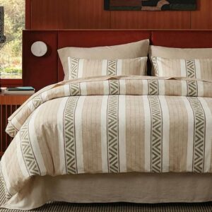 Textured neutral comforter set styled in warm minimalist bedroom