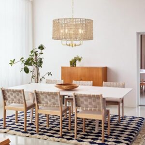 Boho rattan chandelier over neutral dining table with woven chairs and cozy modern farmhouse decor
